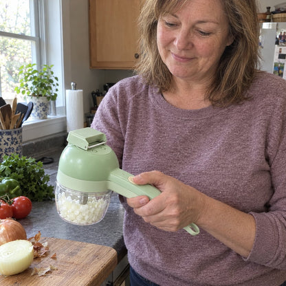 Woman holding the cordless cutter, chopped onion in the clear bowl