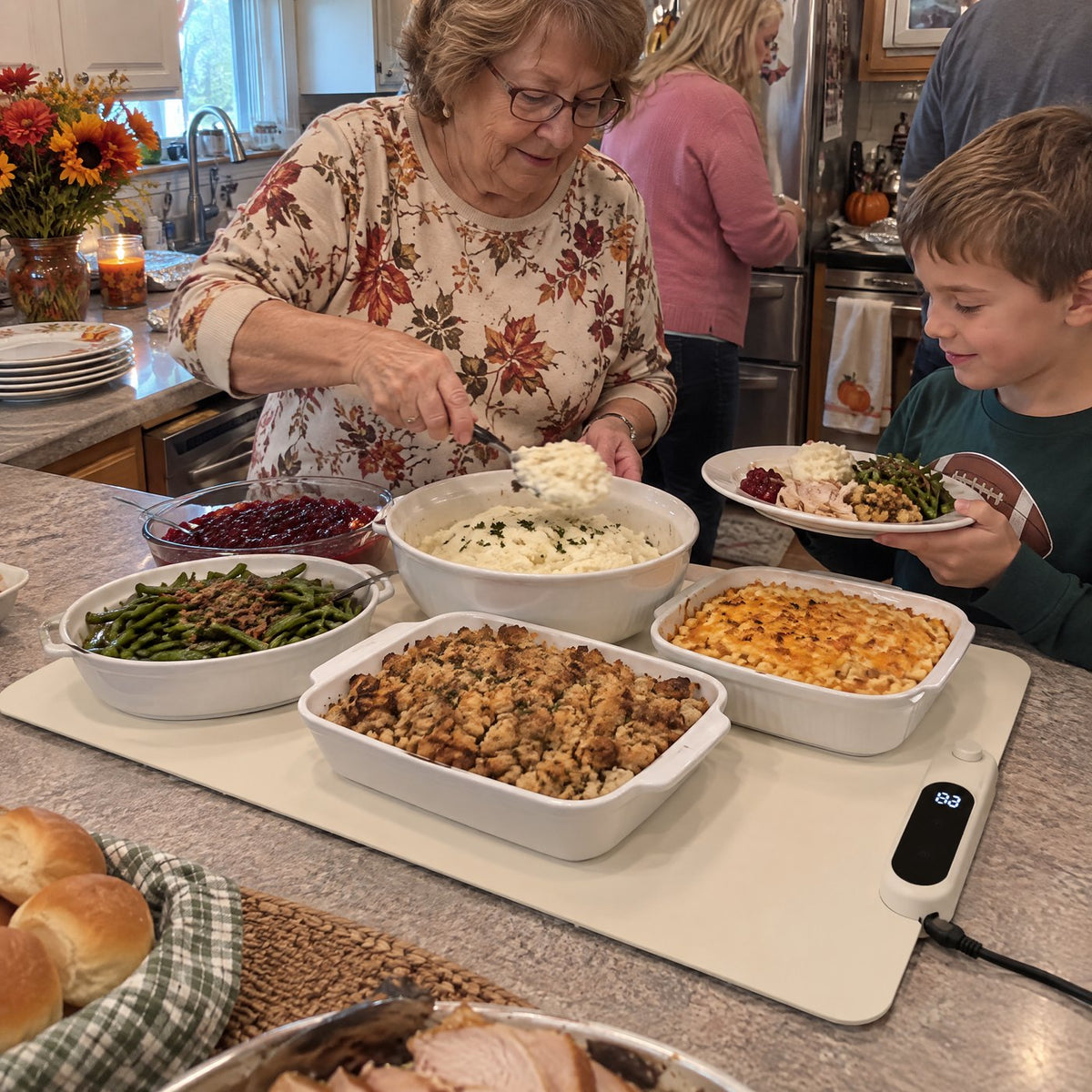 Family serving Thanksgiving dishes kept warm on the mat