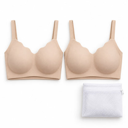 Two beige bras folded side by side, with the wash bag