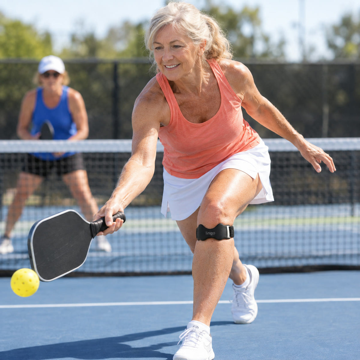 Playing pickleball wearing the strap