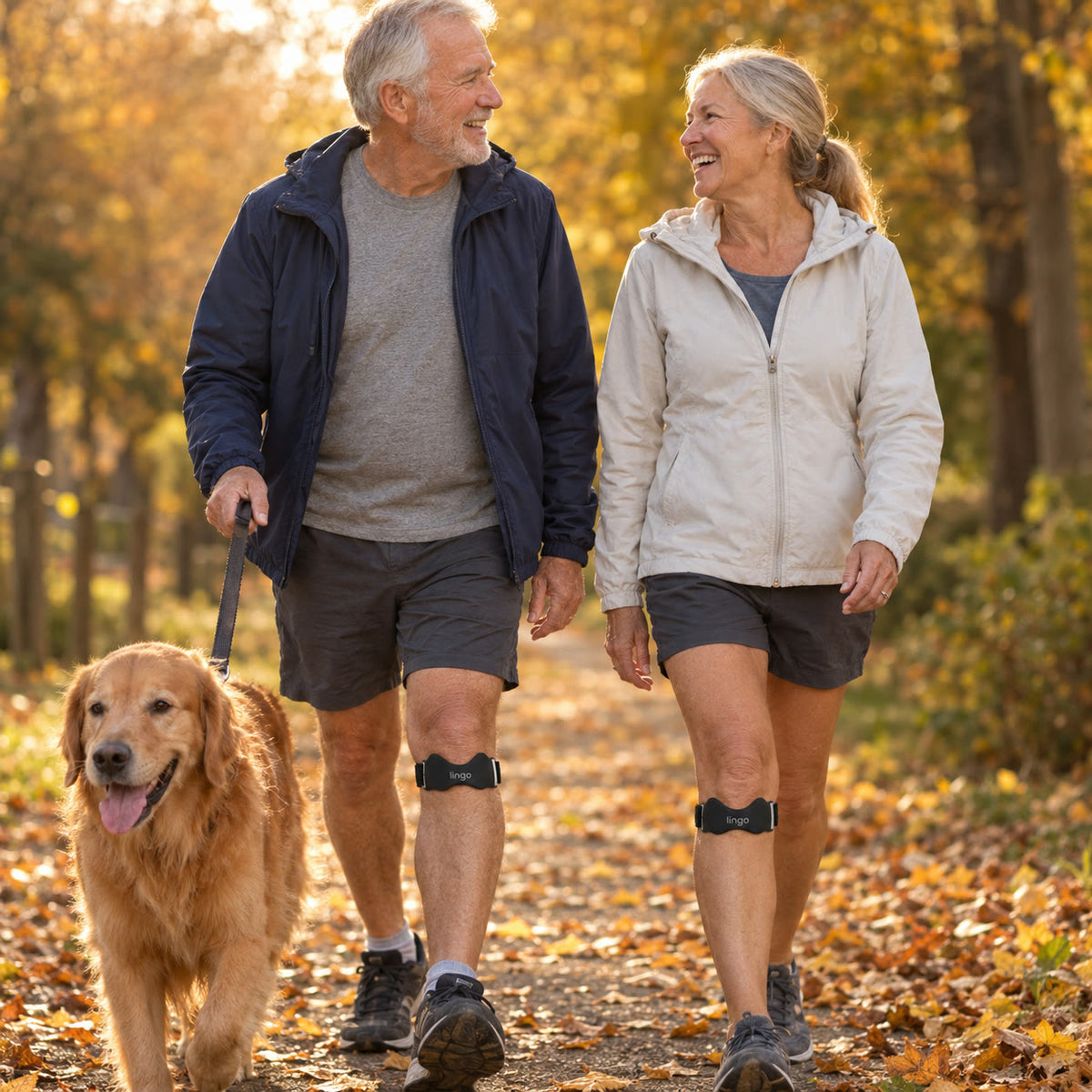 A couple walking their dog, both wearing the strap