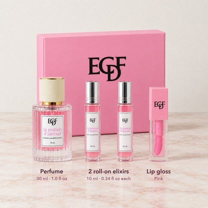 The four pieces lined up in front of the closed pink gift box: 30 ml perfume, two 10 ml roll-ons and a lip gloss