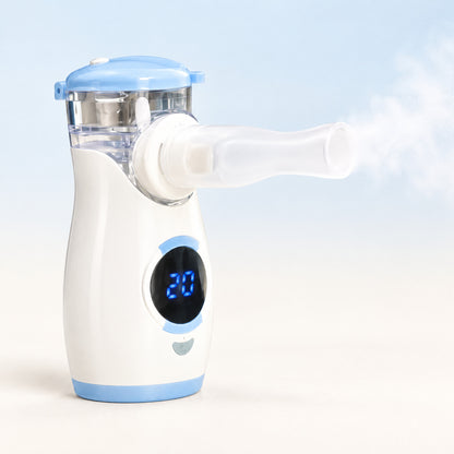 Portable mesh nebulizer, white with a light-blue lid and a round LED display, with a fine mist from the mouthpiece