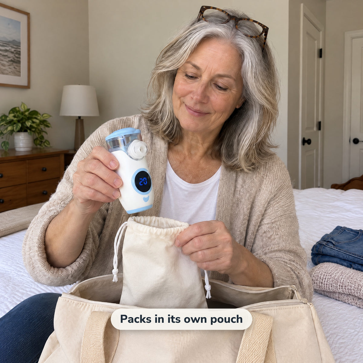 Woman packing the nebulizer in its drawstring pouch into a weekend bag