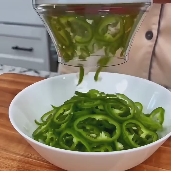 Cucumber slices falling from the cutter into a bowl