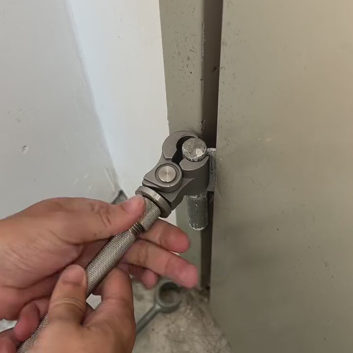 Turning the hinge wrench on a door hinge to straighten the door