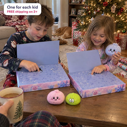 Two siblings by the Christmas tree, each pushing in a door on their own calendar